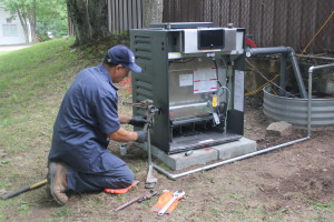 A  technichian repairing a pool heater